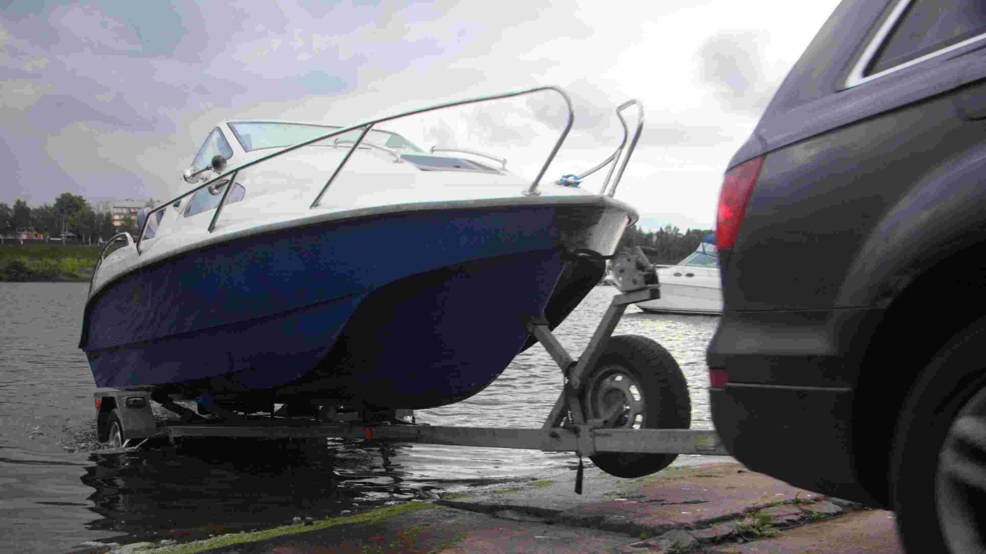 A,4x4,black,car,pulls,blue white,trimaran,cabin,motor,boat