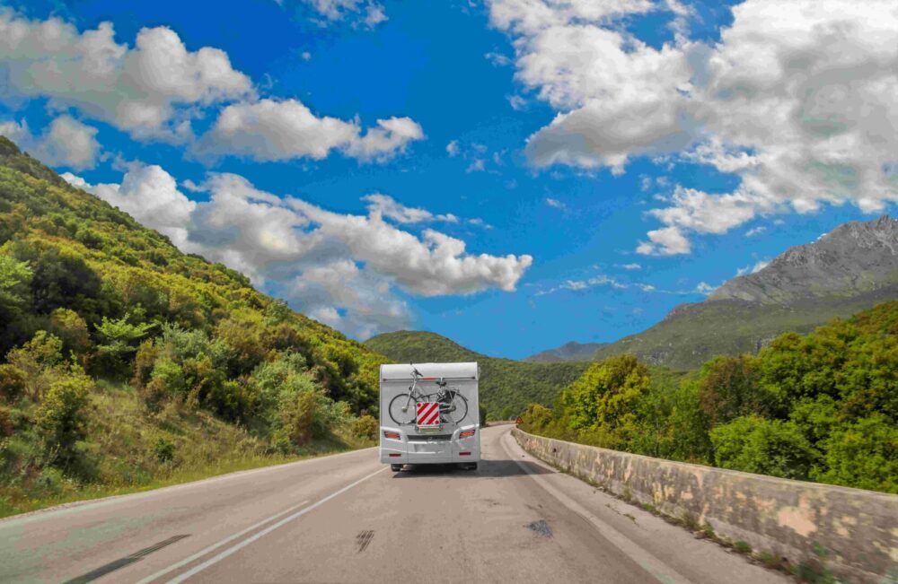 Caravan,car,on,the,road,in,spring,season,green,trees