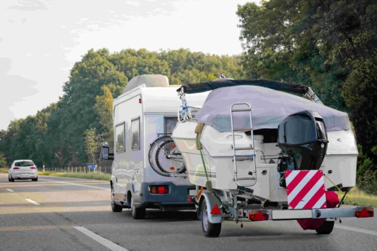 Caravan,with,trailer,for,motor,boats,on,road,in,switzerland.